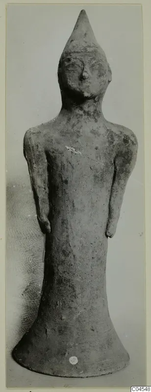 Terracotta figurine of a standing human figure with a tall pointed head and a flared base