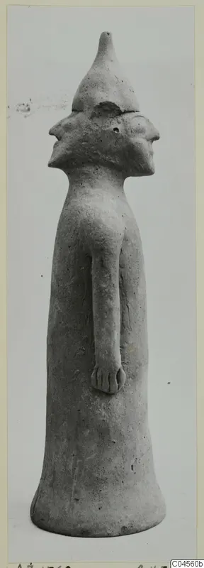 Terracotta Minor Plastic 2: standing terracotta figurine with a conical cap and two profile faces, on a flared base