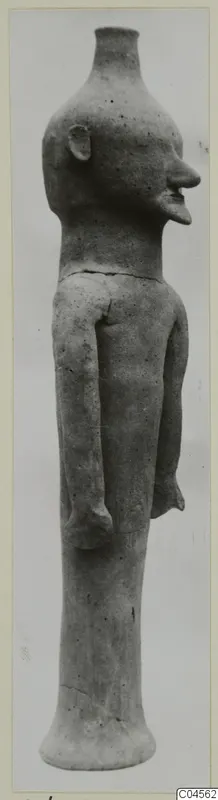 Terracotta standing figure with long arms and a flared base, shown against a plain grey background