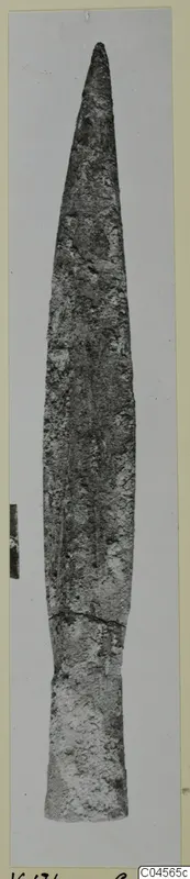 Long pointed bronze blade, a weapon from Vouni, photographed upright on grey card