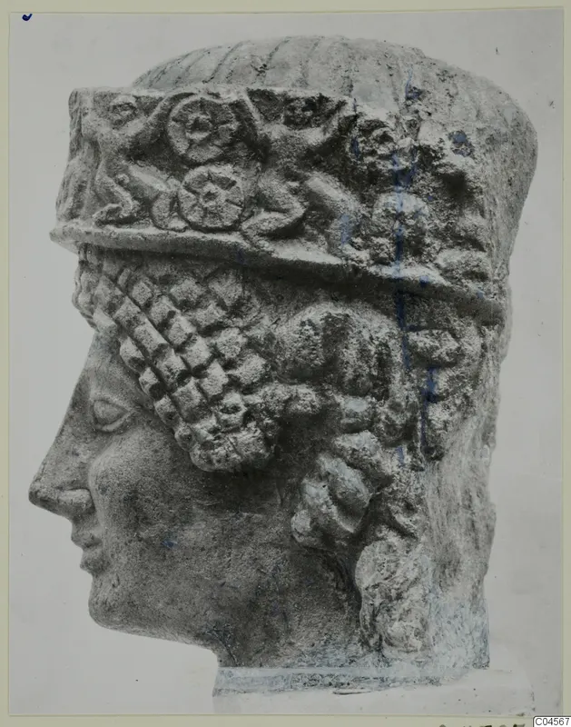 Limestone head from a statue from Arsos, in profile facing left, wearing a tall headdress with a carved relief band