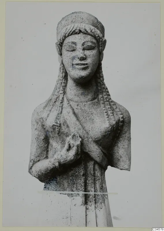 Limestone statue from Arsos of a female figure with braided hair, eyes closed and hands clasped at the chest