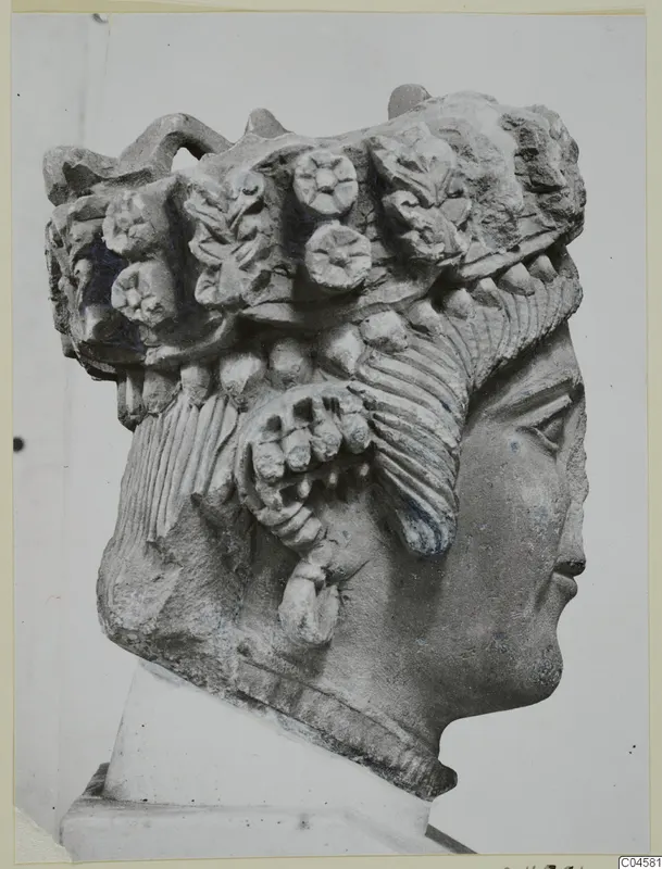 Cypro-Greek II limestone head from Arsos in profile, with a headdress of rosettes and leaves