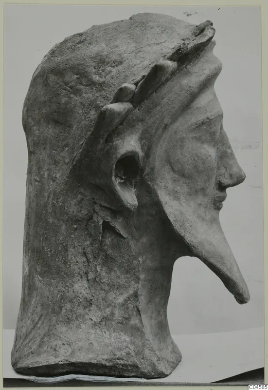 Terracotta head in profile from Mersinaki, with a long pointed nose and a band of leaf-like shapes across the top