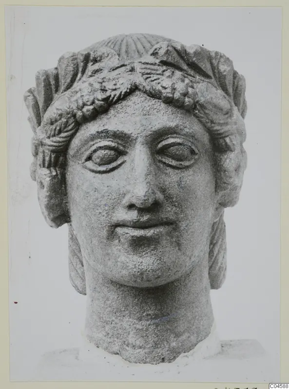 Limestone head of a woman wearing a leafy wreath, from Arsos