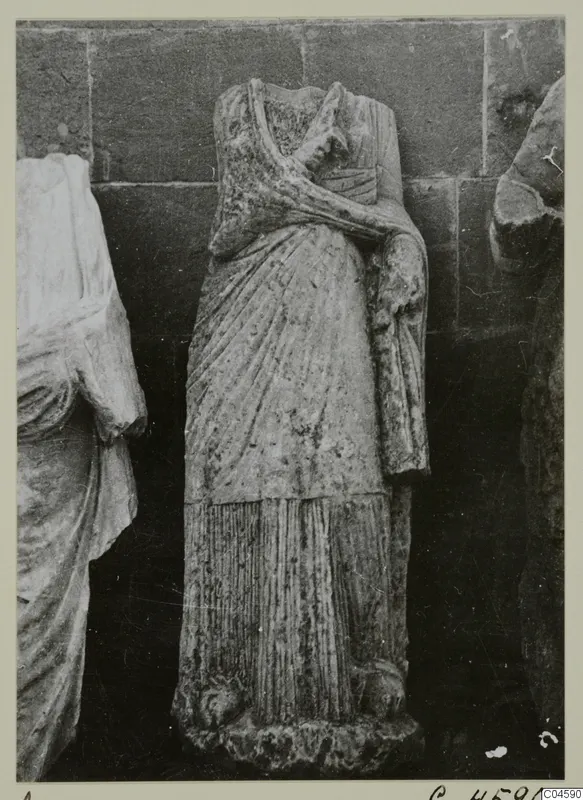 Headless draped standing statue from Arsos with one arm bent across the chest