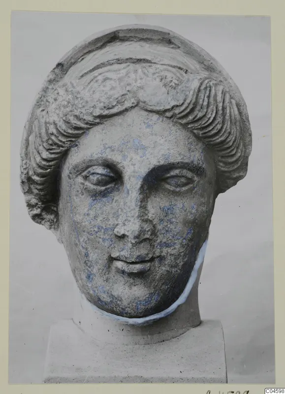 Stone head from Arsos with wavy hair and traces of blue colour on the face