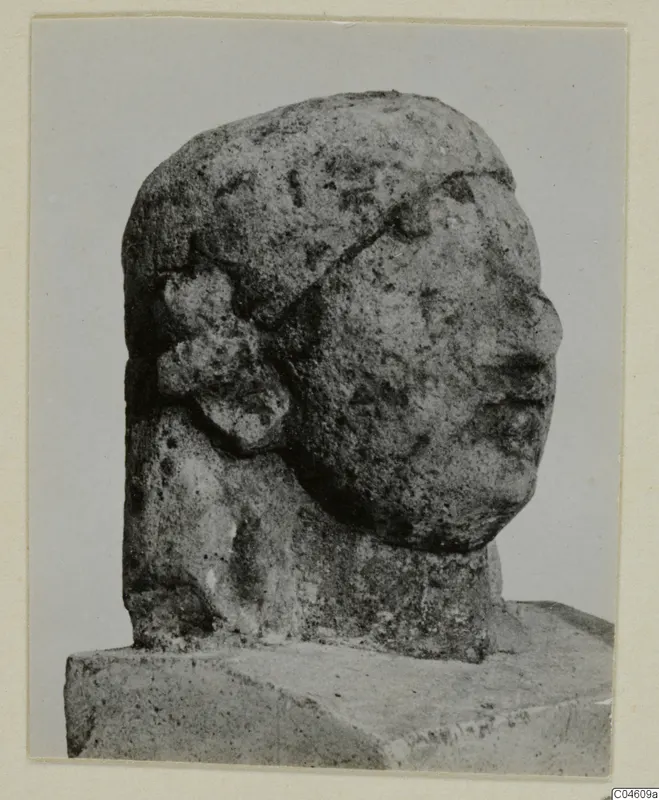 Weathered limestone head in side profile facing right, with a band across the crown, titled Limestone Neo-Cypriote