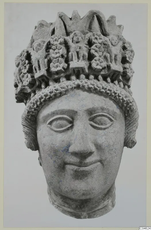 Limestone head sculpture from Arsos, with a tall headdress decorated with rosettes and small raised figures