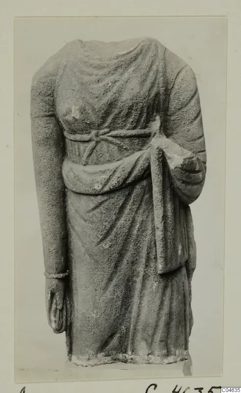 Headless stone statue of a draped standing figure from Arsos, shown from the front