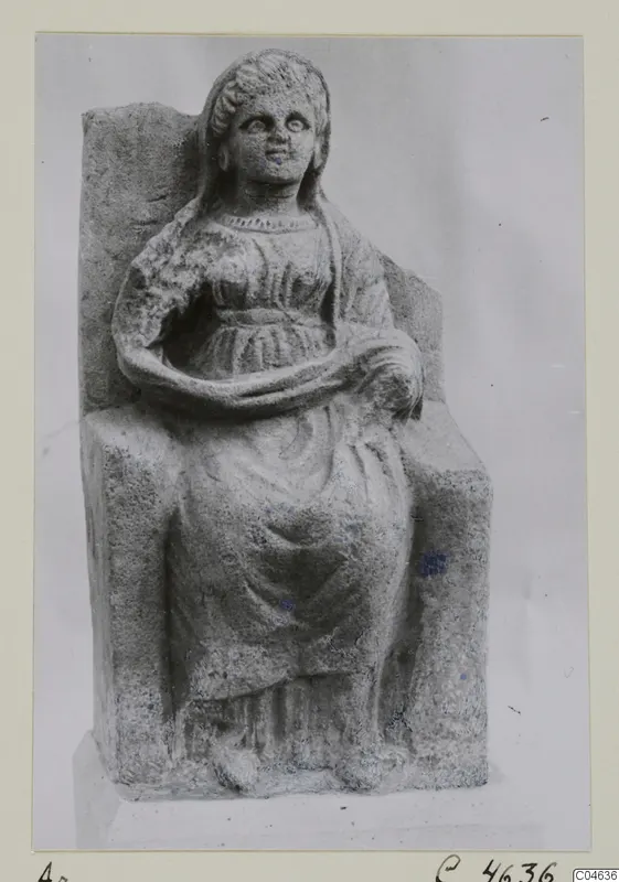 Seated stone statue of a woman from Arsos, shown against a grey backdrop.