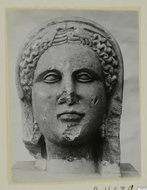 Stone statue head from Arsos, front view, with curled hair and a band across the brow.