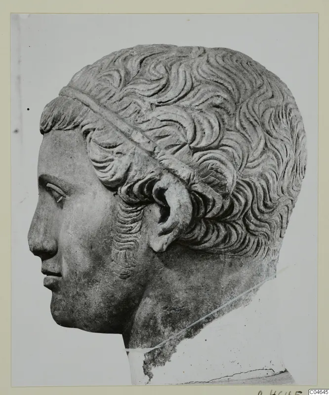 Stone head from a statue at Arsos, shown in left profile, with short wavy hair and a band across it.