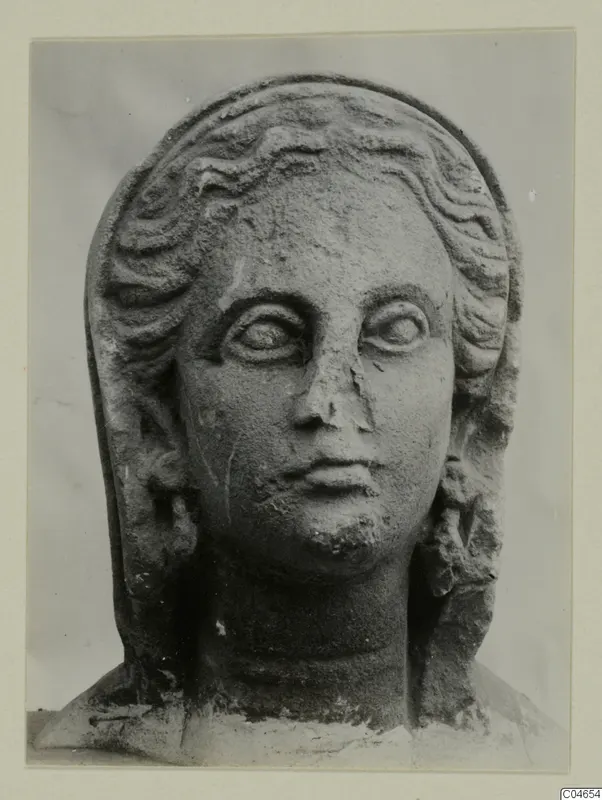 Stone head from Arsos with wavy hair in bands and a veil framing the face