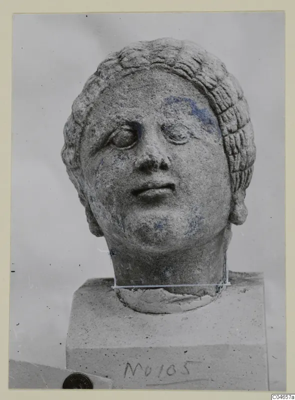 Stone statue head from Arsos, a female head with hair in wavy rows, on a square block base
