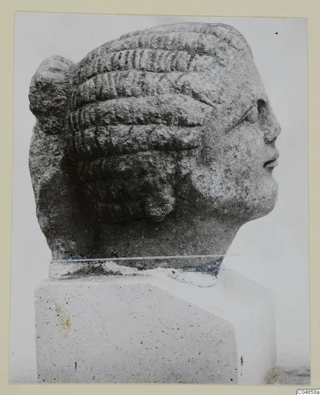 Stone statue head from Arsos, shown in profile facing right, with tiered ridged hair