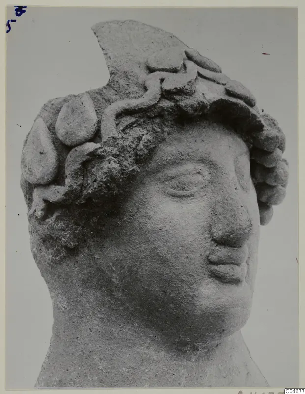 Head of a sculpture from Mersinaki, with a wreath-like headdress of rounded forms and a broken top