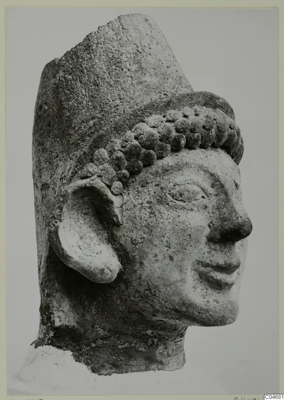 Head of a figure in stone with a tall flat-topped headdress and rows of curled hair, from Mersinaki