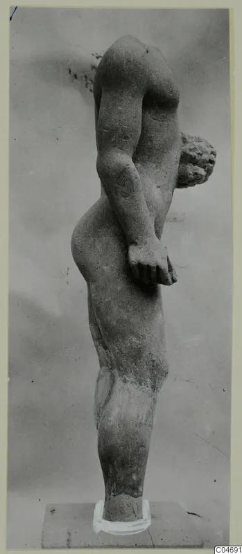 Limestone statue of a standing male nude from Mersinaki, seen from the side with one arm bent across the body