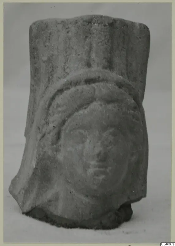 Small fragment of a moulded terracotta figure with a head in relief, from Soli.