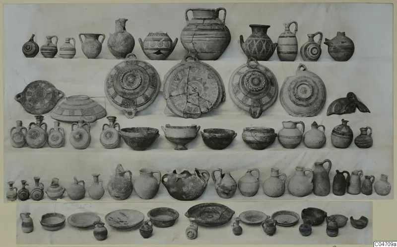Pottery vessels from Amathus Tomb 11: jugs, juglets, bowls and dishes laid out in rows on a light ground