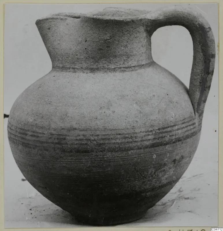 Pottery jug with a high loop handle and bands of dark painted lines around the body, from Amathus.