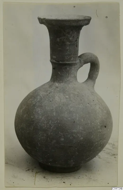 Grey-brown jug with a flared rim, a single strap handle and a ring base, from Amathus.