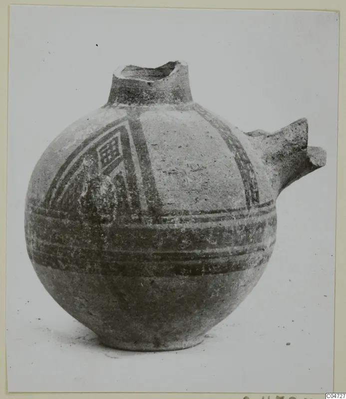 Globular pottery vessel with a short neck, broken spout, and dark painted bands with a lattice panel on the shoulder.