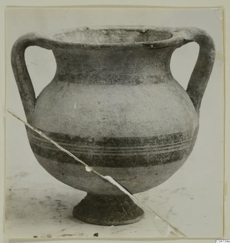 Two-handled pottery amphora with a footed base and dark painted bands, from Amathus.