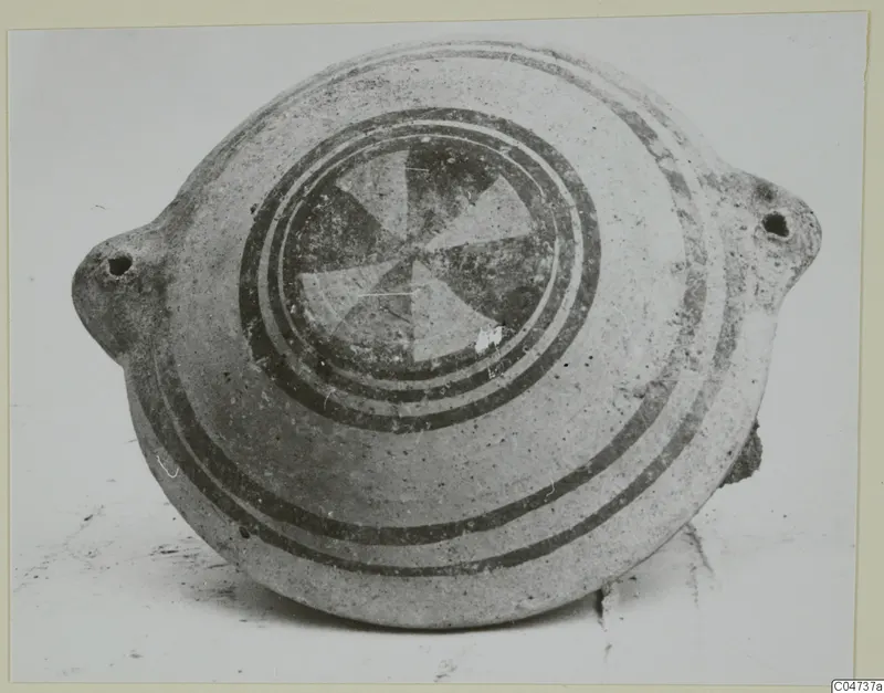 White Painted II pottery vessel from Amathus, flattened round body with pierced lugs, painted bands and a central segmented motif