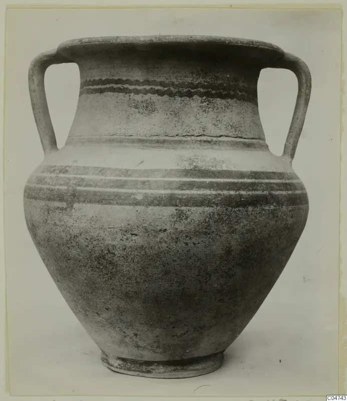Two-handled White Painted II pottery vessel with dark painted bands and a wavy band on the neck