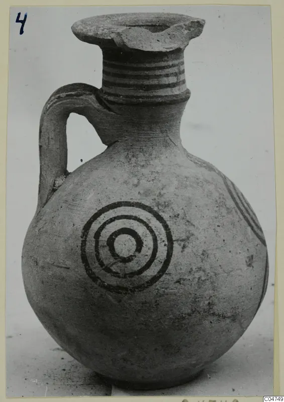 Jug with a round body, a loop handle, banded neck and concentric circles painted on the body.
