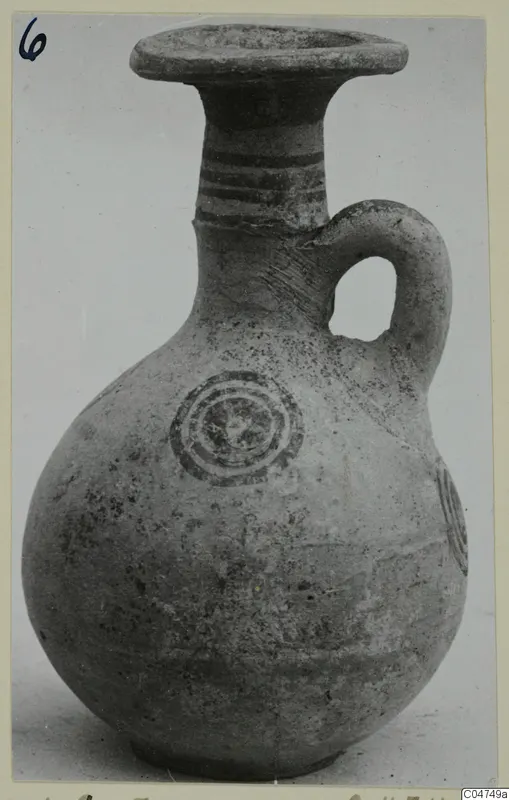 Jug from Amathus with a flared rim, loop handle, dark painted bands and concentric circles on the body