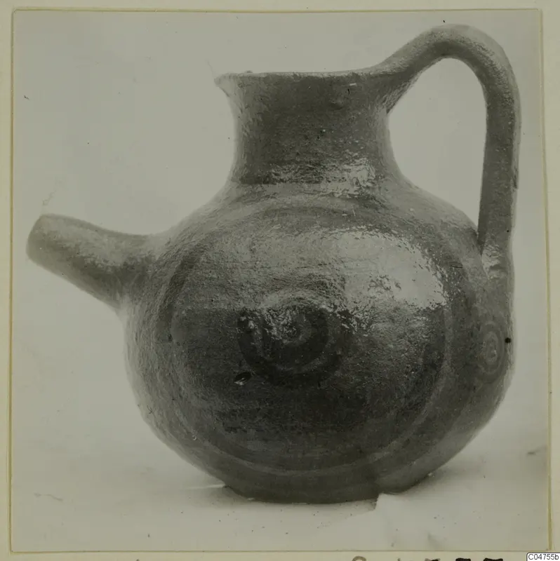 Pottery White Painted IV jug with side spout and strap handle, dark painted spirals on the body