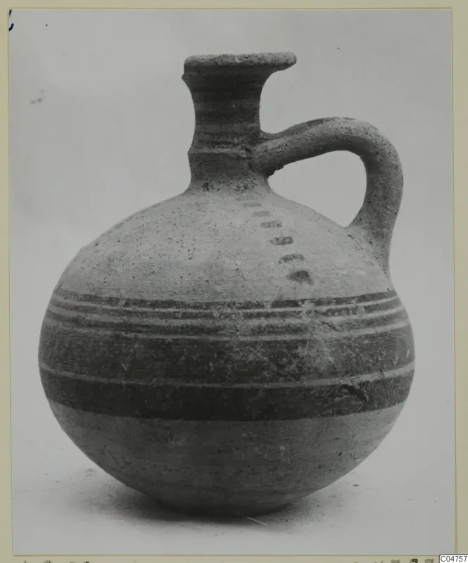 Jug of Pottery Bichrome IV type from Amathus, with dark painted bands around the body and a single loop handle