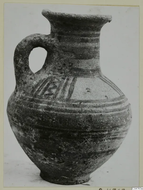 Pottery Bichrome III jug with a loop handle, dark painted bands and a hatched pattern on the shoulder