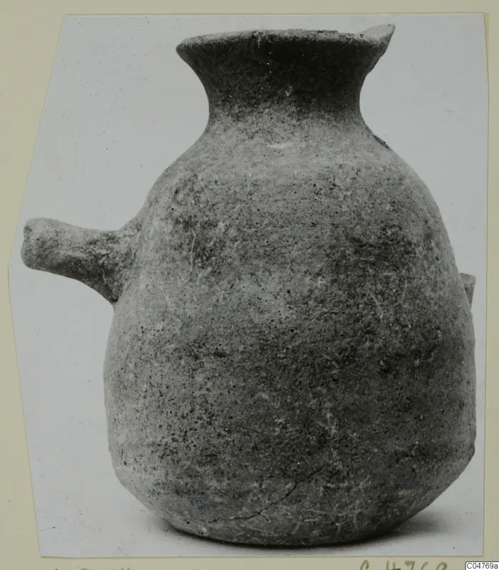 Round-bodied pottery vessel with a flared neck and a short horizontal lug handle on one side.