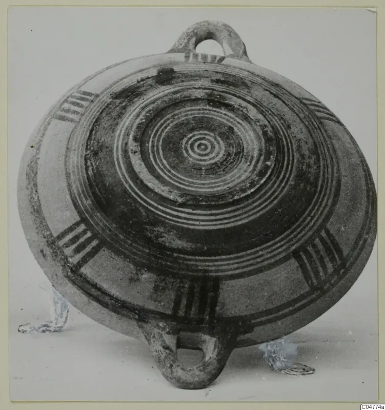Pottery Bichrome III, a flat round vessel with concentric painted rings and two loop handles