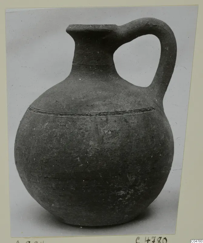 Pottery jug with one handle, globular body and a raised ridged band around the shoulder, from Amathus tombs