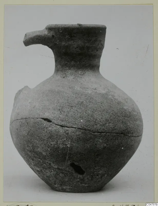 Pottery Plain White IV-V vessel from Amathus with a spout-like lip, narrow neck and globular body, cracked and chipped.