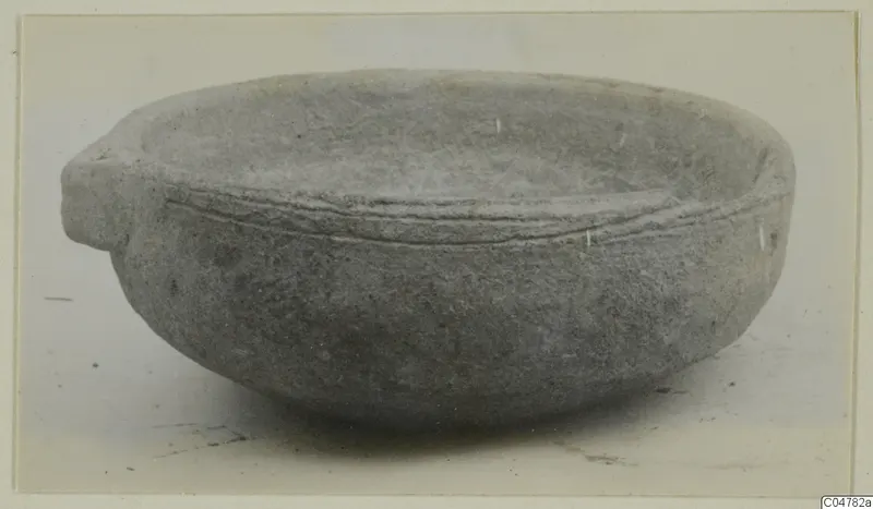 Grey bowl with a small projecting handle on the left and a raised band around the outside below the rim.
