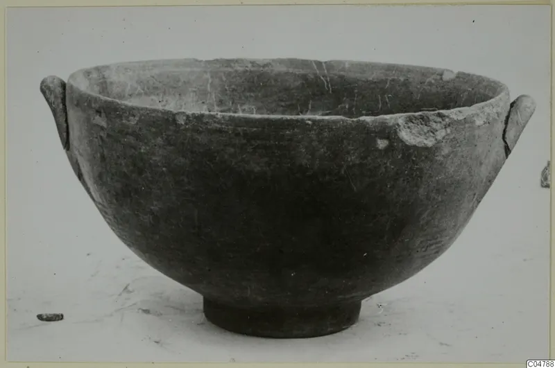 Pottery bowl with two small handles and a ring foot, recorded as Pottery Black-on-Red I-III