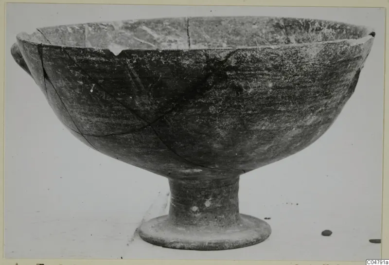 Footed pottery bowl with a chipped rim and a small handle stub, from Amathus, Pottery Black-on-Red I-III