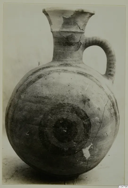 Pottery Bichrome I jug from Amathus with a flared neck, strap handle and dark concentric circles on the body