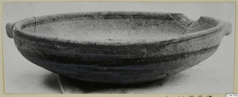 Pottery Bichrome IV plate-jug from Amathus: a shallow bowl with two small handles and dark painted bands