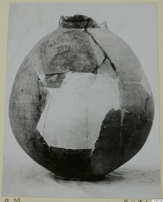 Globular jug reconstructed from sherds, with faint painted decoration on the upper body