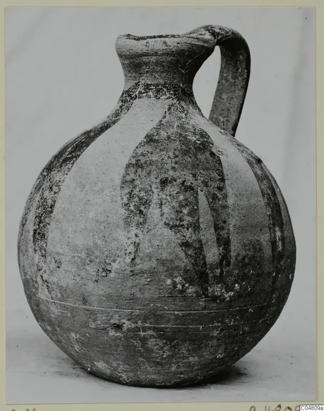 Round-bodied jug with a tall neck, loop handle and dark painted vertical bands, photographed on a plain background.