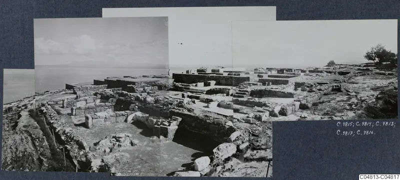 Overview of Vouni Palace ruins: stone walls and foundations on a hilltop, with the sea beyond.