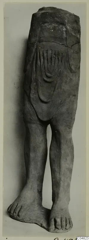 Terracotta figure of legs and lower body with curved relief lines on the torso; upper part broken away