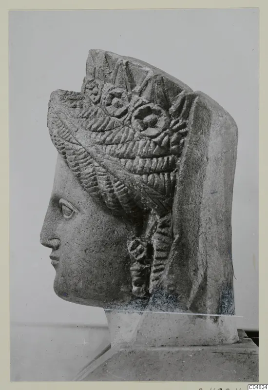 Carved stone head of a woman in profile facing left, with an elaborate layered headdress, from Arsos.